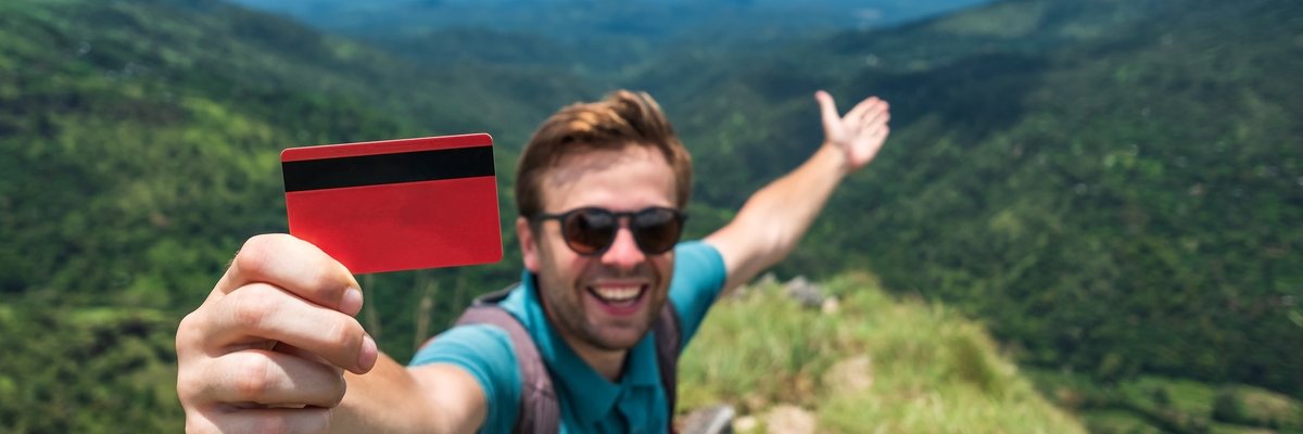 Traveler with credit card in mountains