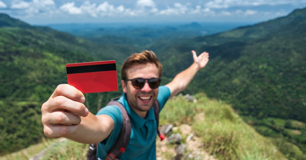 Traveler with credit card in mountains