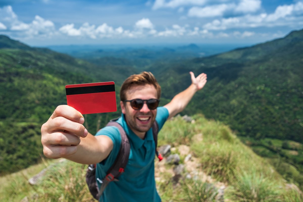 Traveler with credit card in mountains