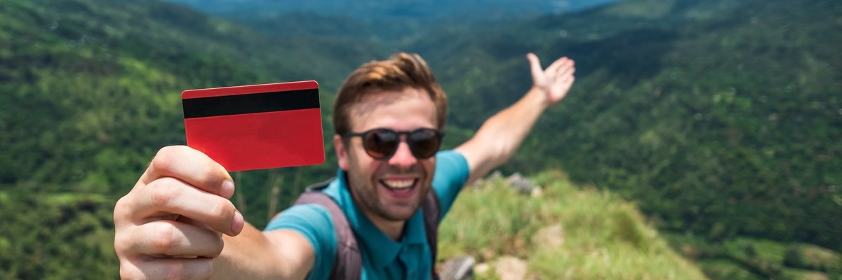 Traveler with credit card in mountains