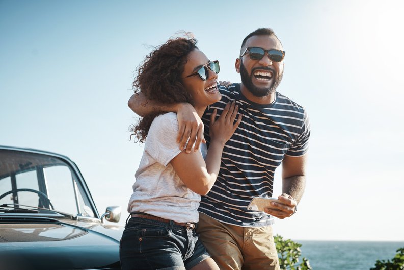 Two Happy People With a Car