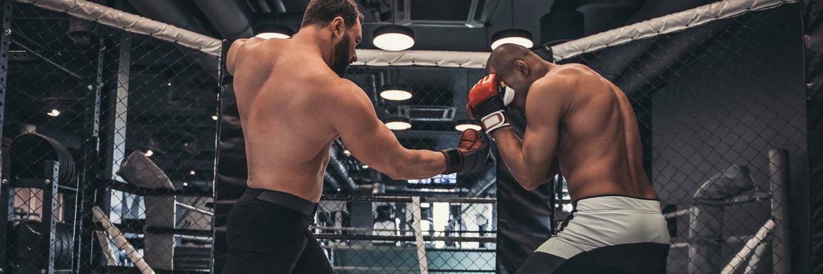 Two mma fighters facing off in the ring.
