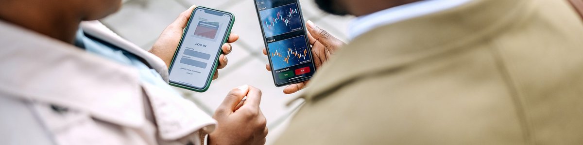 Two people looking at asset prices on investing apps.