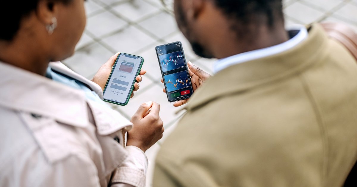 Two people looking at asset prices on investing apps.
