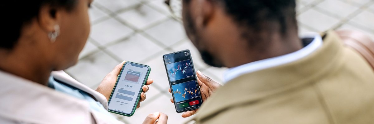 Two people looking at asset prices on investing apps.