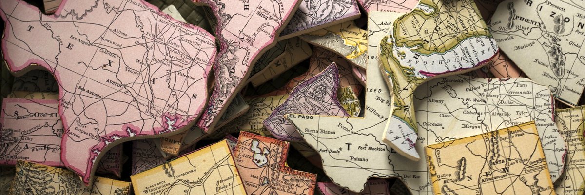 A pile of US states cut out of a map.