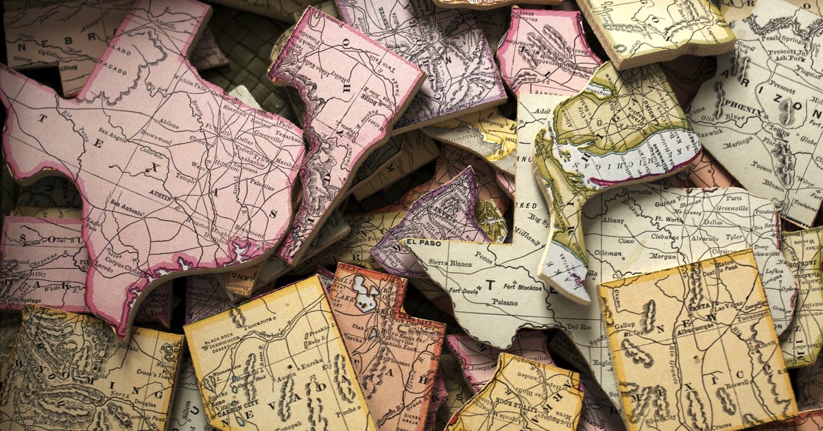 A pile of US states cut out of a map.