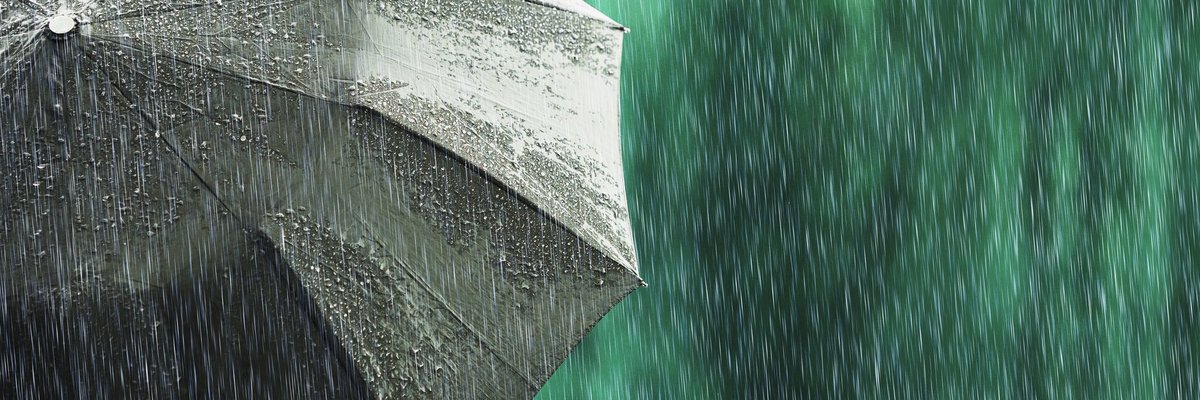 An open umbrella in a light rain.