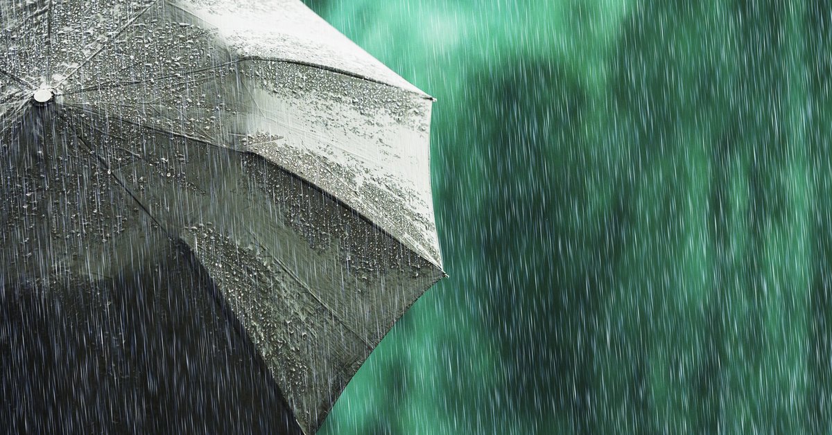 An open umbrella in a light rain.