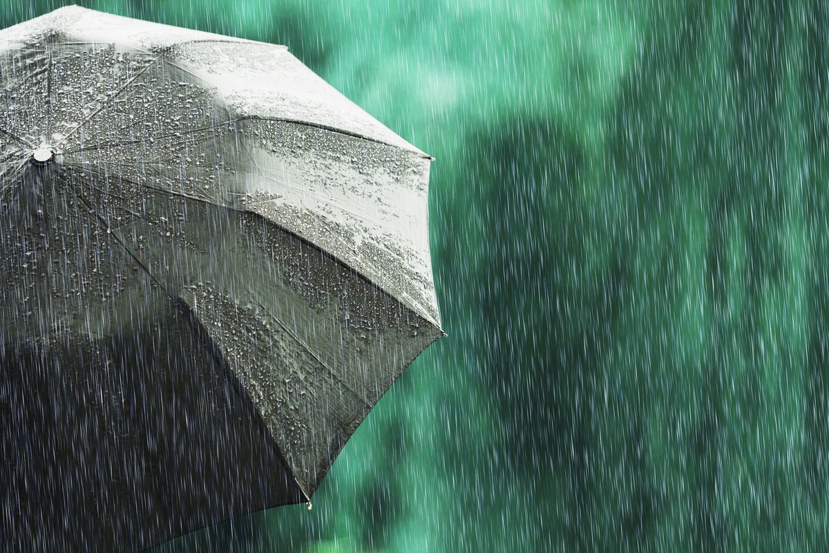An open umbrella in a light rain.