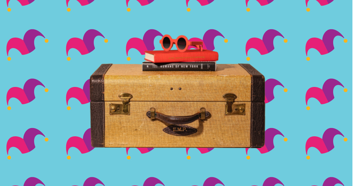 A suitcase with a book and pair of sunglasses on top of it.