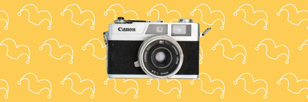 A camera against a yellow background.