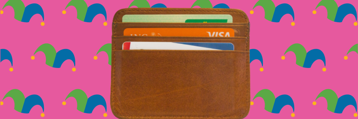 A wallet against a pink background.