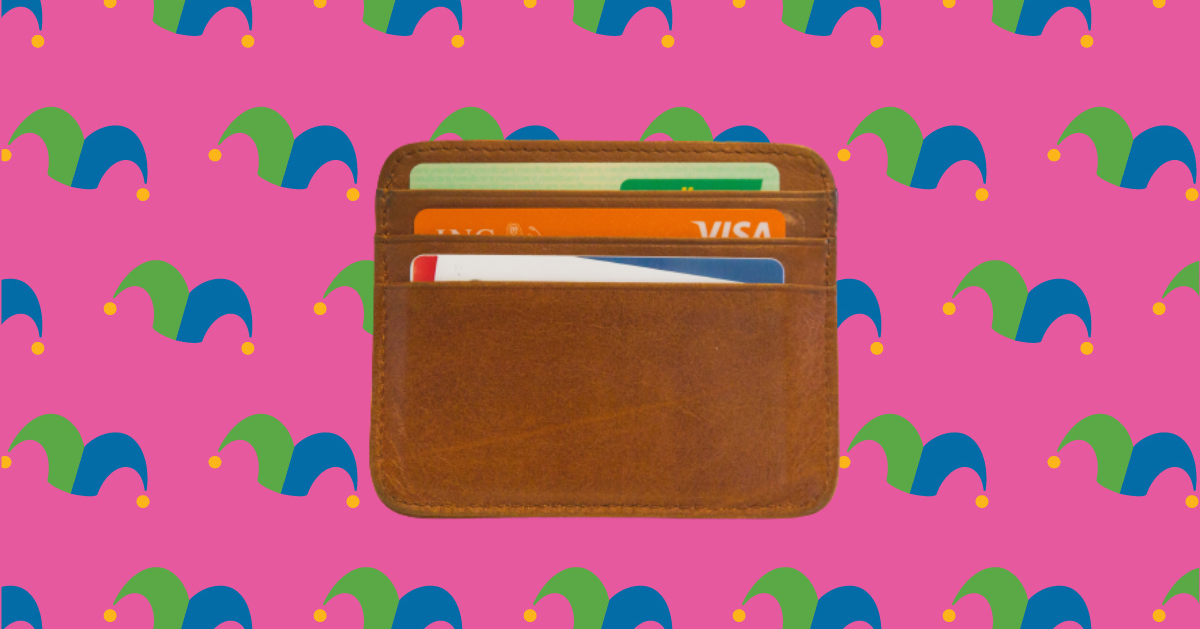 A wallet against a pink background.