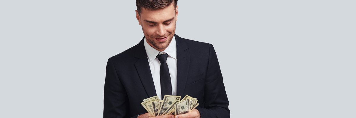 Man in a suit counting money.