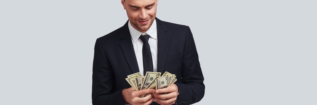 Wealthy man in a suit counting money.