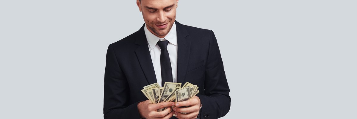 Wealthy man in a suit counting money.