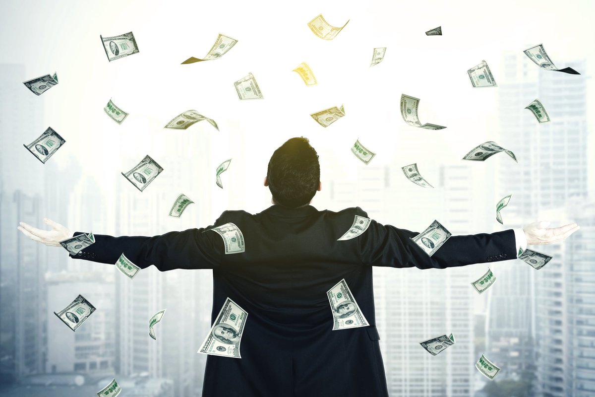 Business Man Spreading Arms As Money Rains On Him