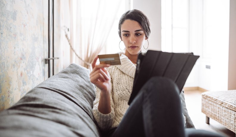 Woman Looking at Her Credit Card