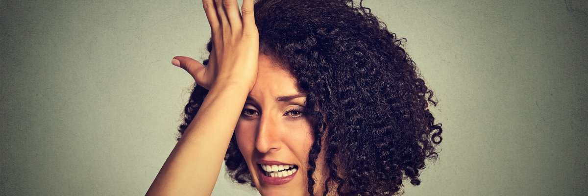 Woman Slapping Forehead With Regret
