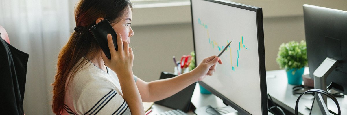 Woman following upward trending line on graph