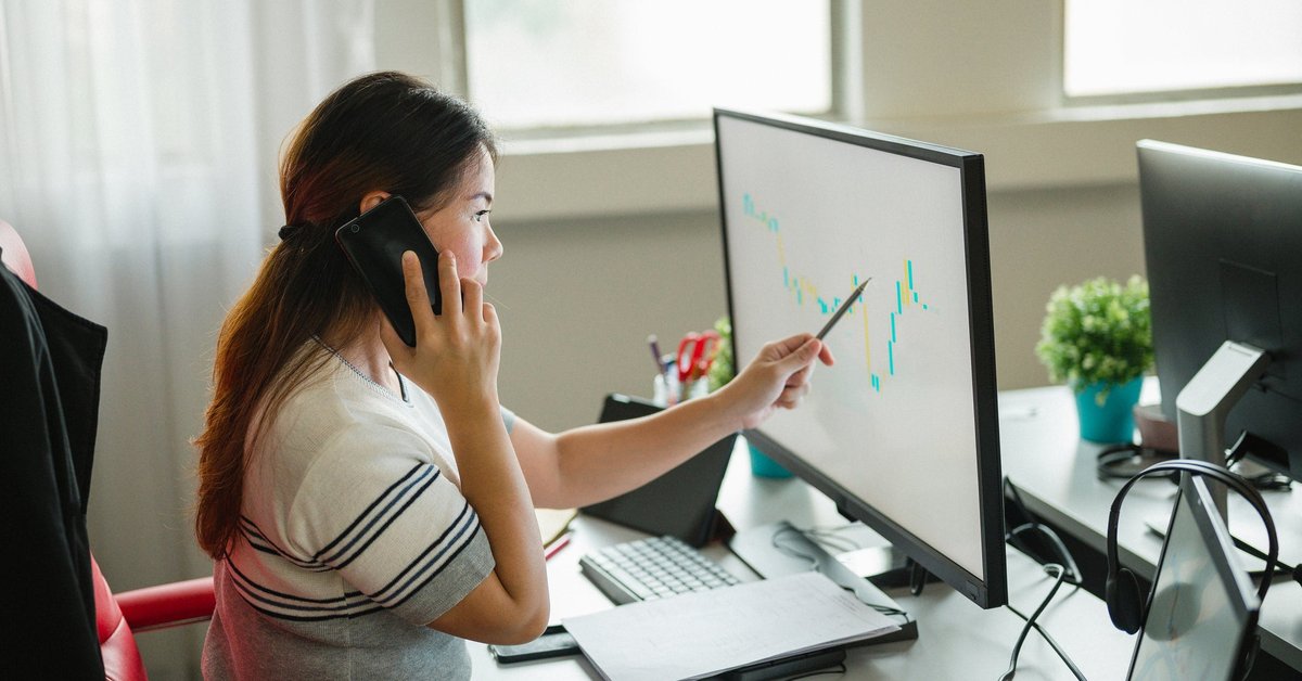 Woman following upward trending line on graph