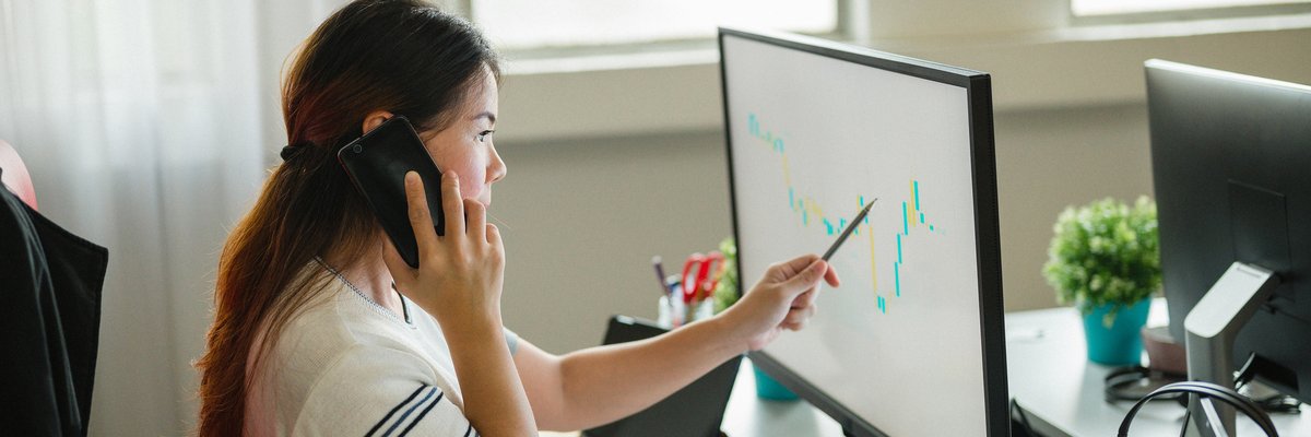 Woman following upward trending line on graph