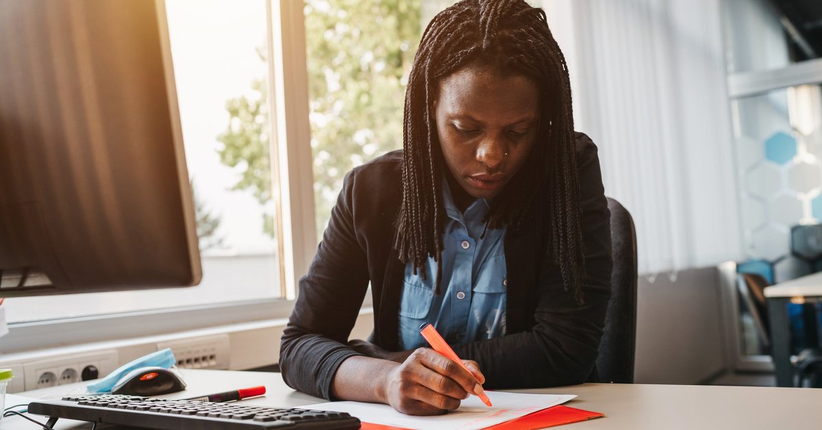 Woman highlighting a document.