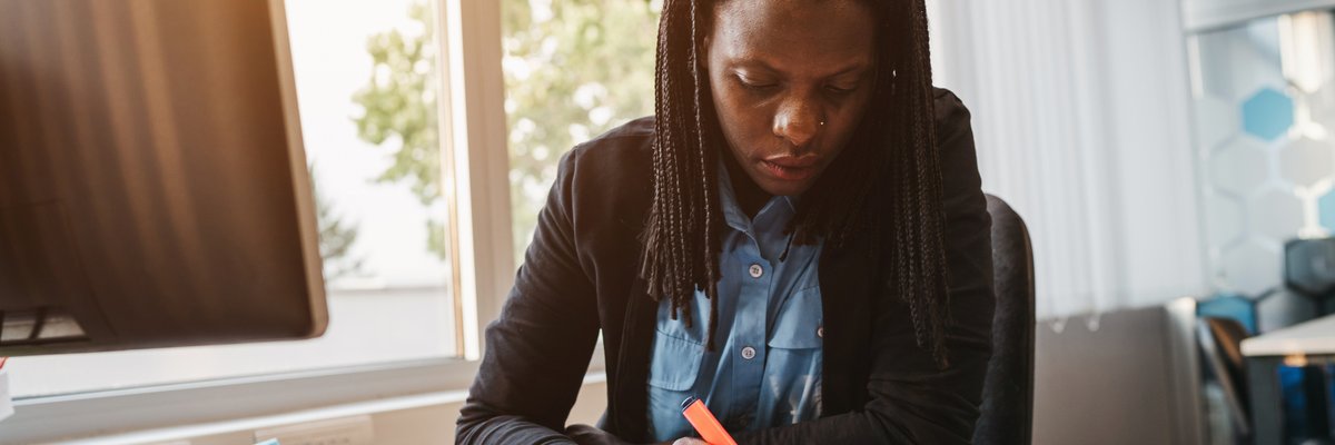Woman highlighting a document.