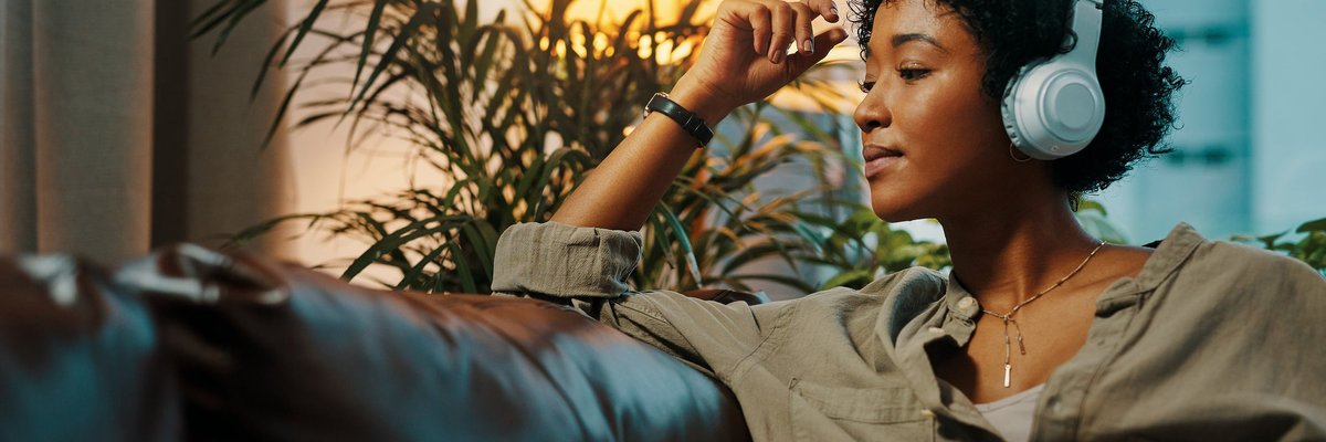 Woman listening to music through headphones.
