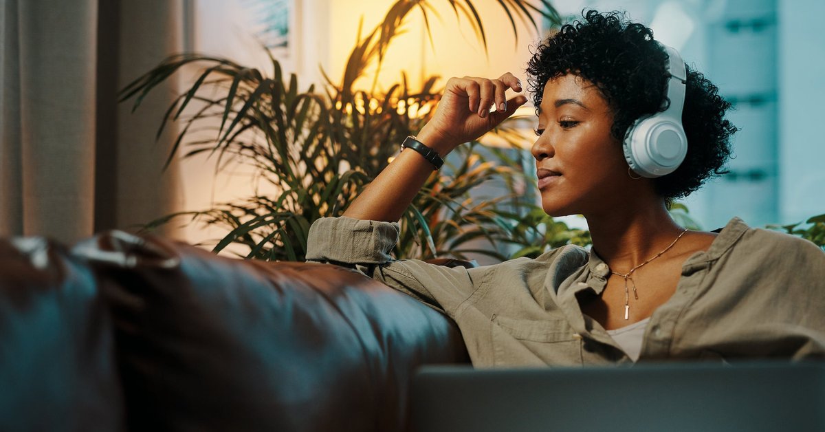 Woman listening to music through headphones.
