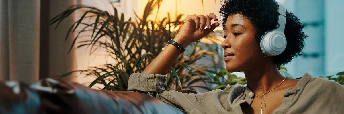 Woman listening to music through headphones.