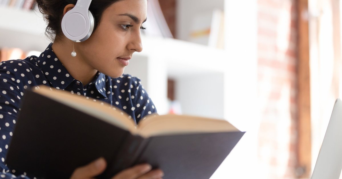 Woman looking up information in a book.