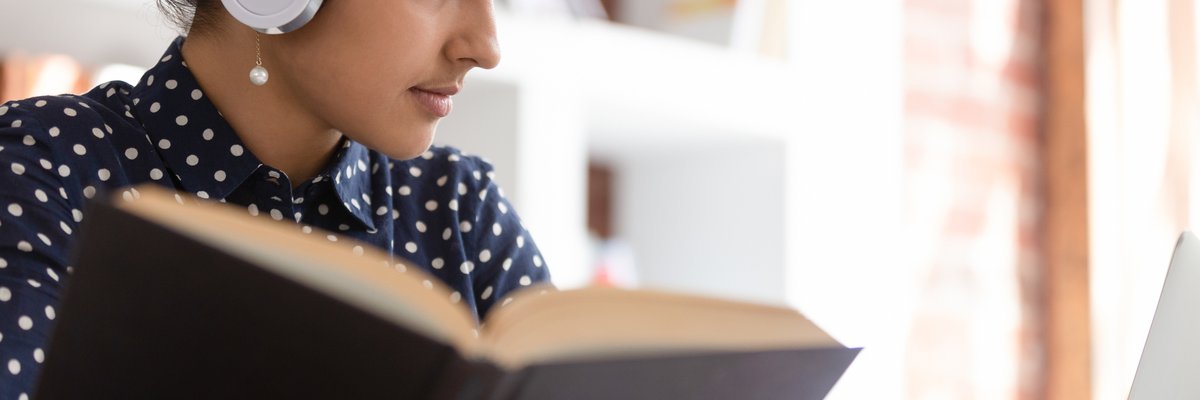 Woman looking up information in a book.