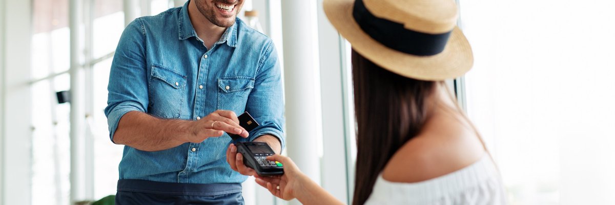 Woman paying waiter credit card