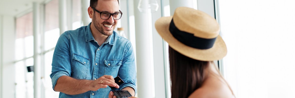 Woman paying waiter credit card