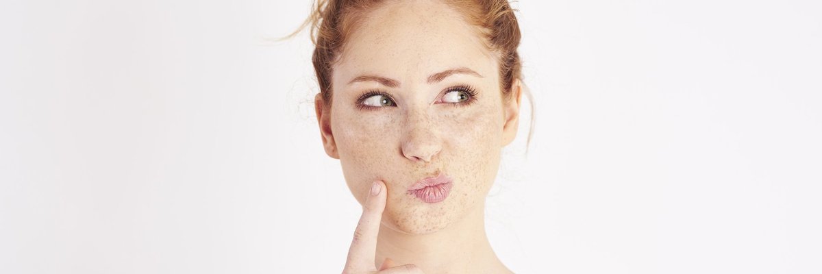 Woman thinking with her pointer finger resting on her cheek