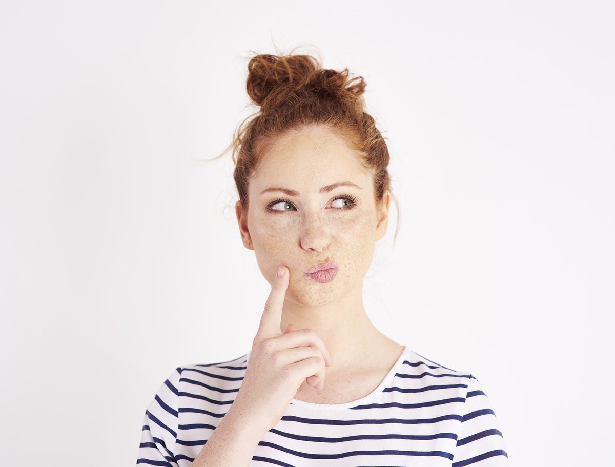Woman thinking with her pointer finger resting on her cheek
