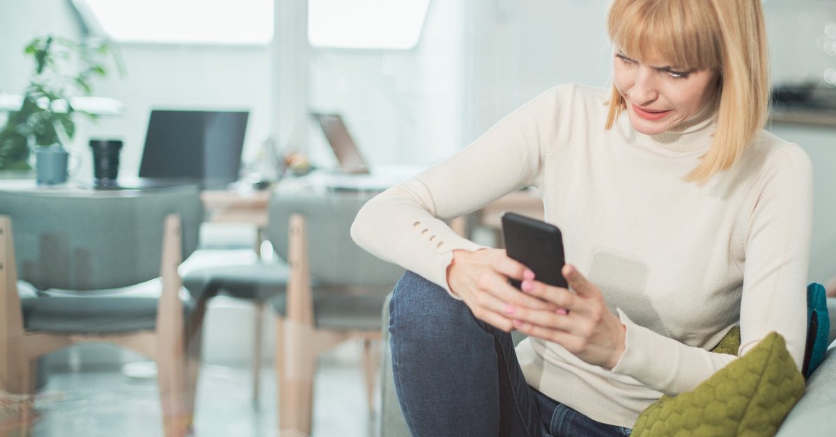 Woman uncomfortable by what she's reading on her phone.
