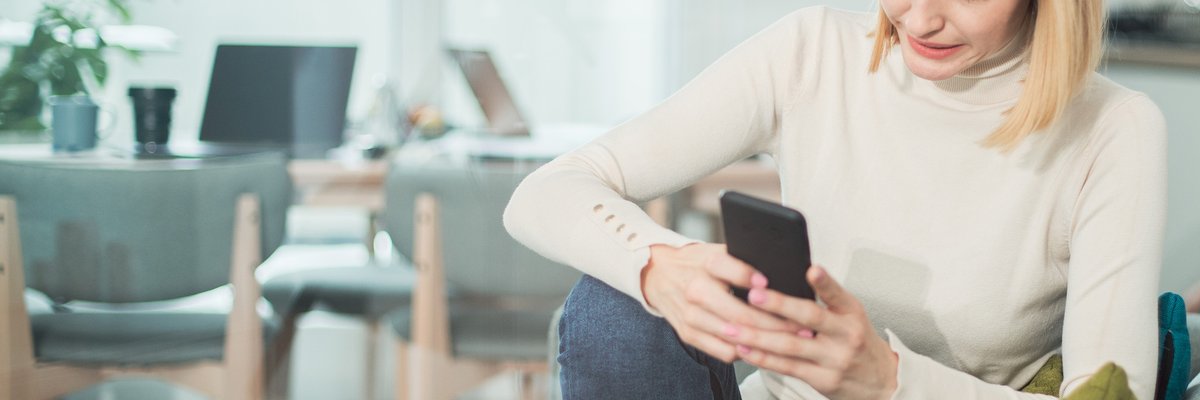 Woman uncomfortable by what she's reading on her phone.