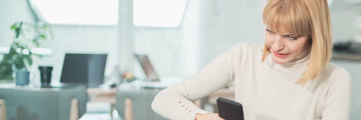 Woman uncomfortable by what she's reading on her phone.
