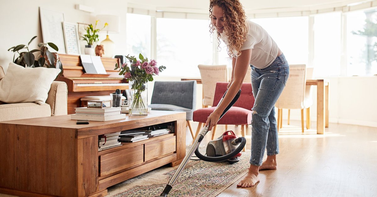 Woman vacuuming her living room