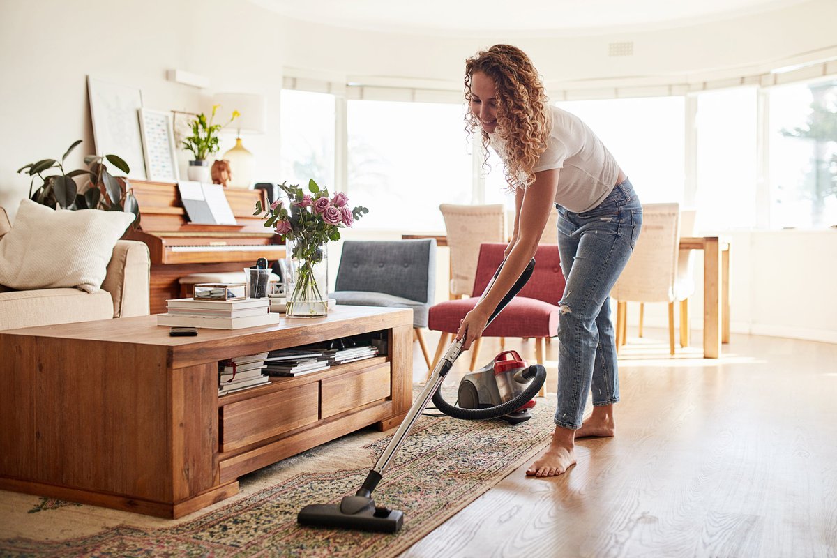 Woman vacuuming her living room