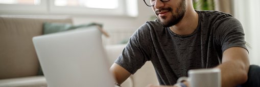 Young Man Looking At Laptop