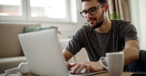 Young Man Looking At Laptop