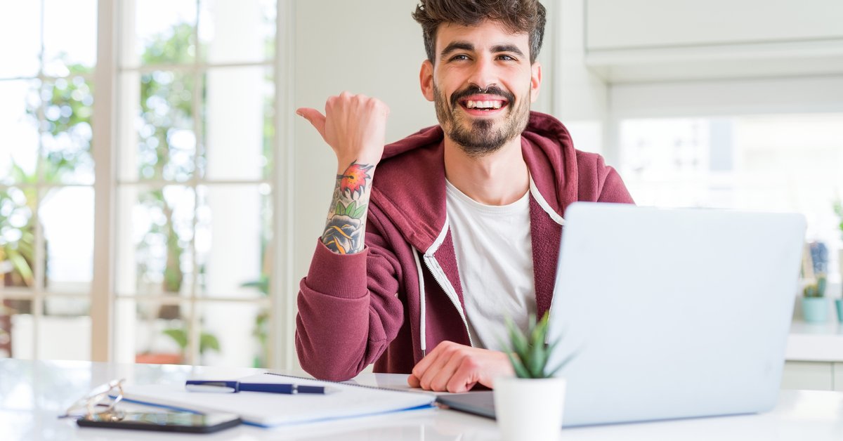 Young Man With Books And Laptop