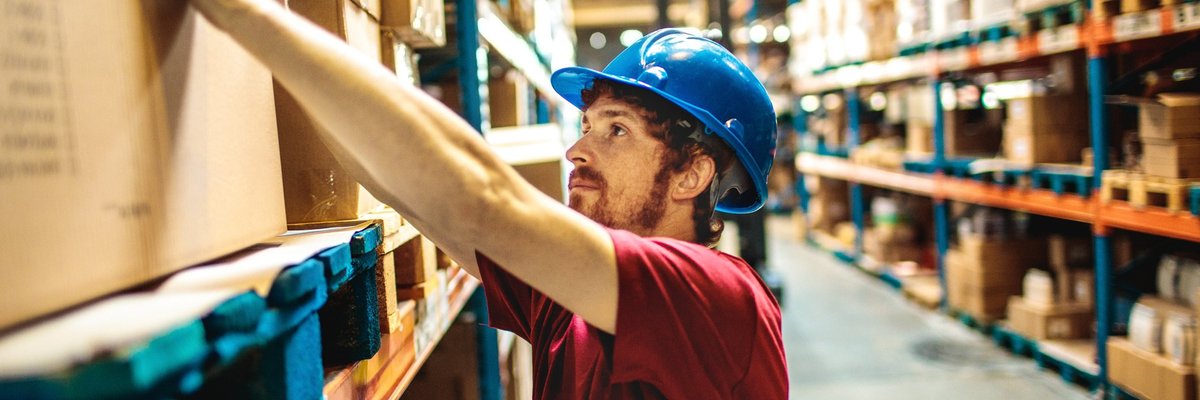 Young Man Working In Warehouse