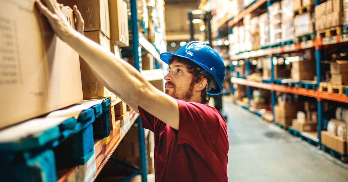 Young Man Working In Warehouse