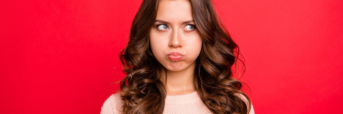 Young Woman Blowing Up Her Cheeks