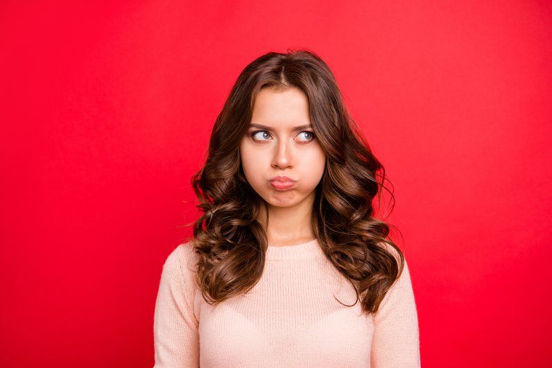 Young Woman Blowing Up Her Cheeks